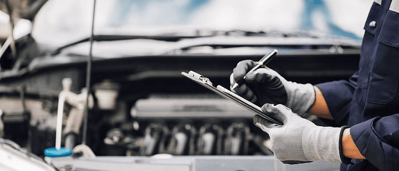 Mechanic inspecting car for roadworthy test in Brendale